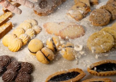 Frolla senza glutine, biscotti di mandorle e cioccolato, dolci artigianali, preparazione pasticcera, dolciumi, biscotti fatti in casa, dessert tradizionali, specialità dolciarie, texture morbida e croccante, decorazioni di pasticceria, prodotti dolciari italiani, delizie per ogni occasione.